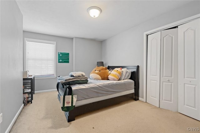 bedroom featuring light carpet and a closet