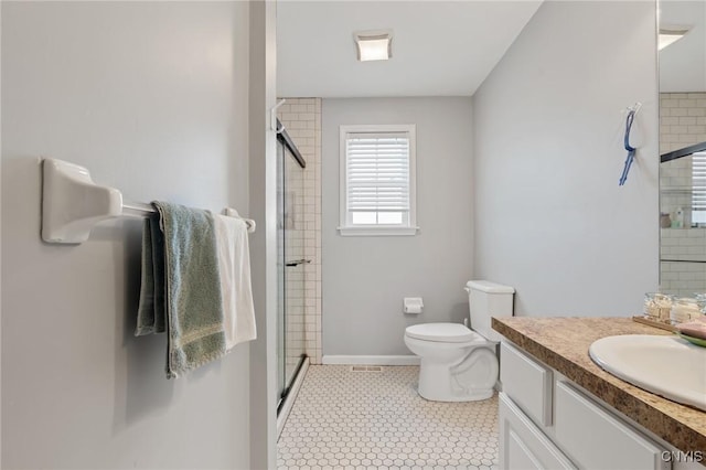 bathroom with vanity, tile patterned flooring, toilet, and walk in shower