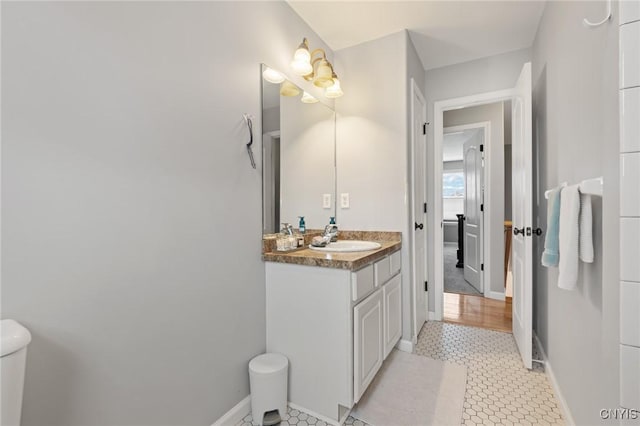 bathroom featuring vanity, tile patterned floors, and toilet