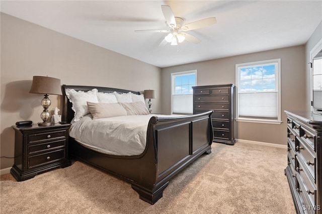 bedroom with ceiling fan and light carpet