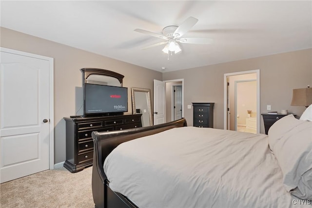 carpeted bedroom with ceiling fan and ensuite bath