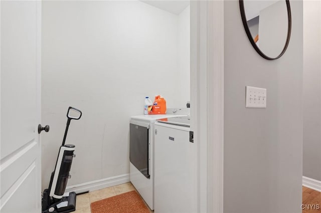 washroom with washing machine and clothes dryer and light tile patterned floors