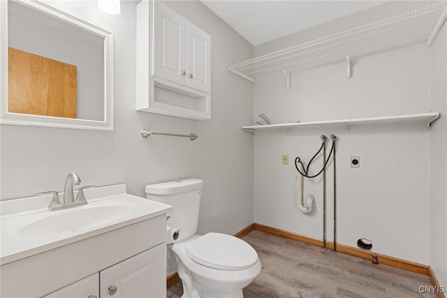 bathroom with vanity, hardwood / wood-style floors, and toilet