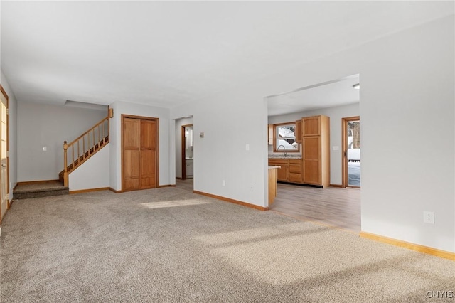 unfurnished living room with light carpet