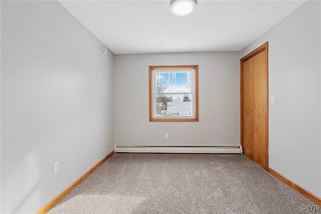 unfurnished room featuring a baseboard radiator and carpet flooring