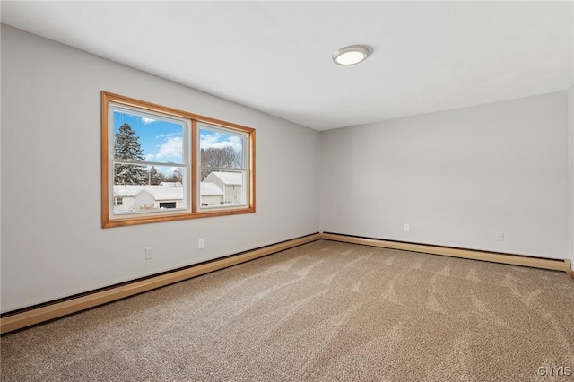 carpeted empty room with a baseboard heating unit