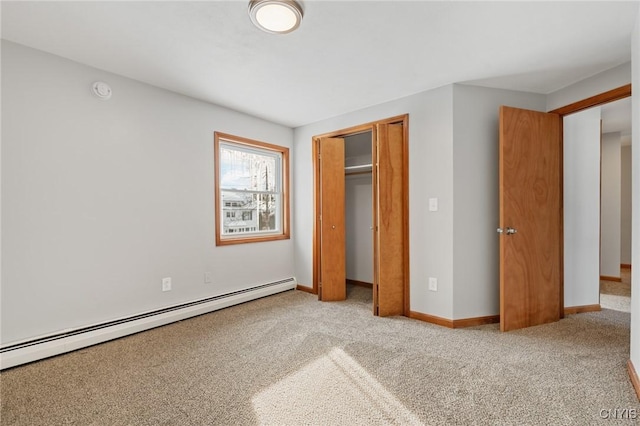 unfurnished bedroom featuring a baseboard radiator, a closet, and light carpet