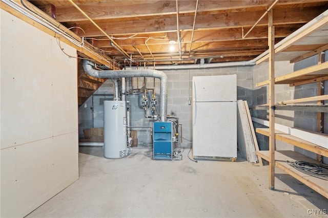 basement with gas water heater and white fridge