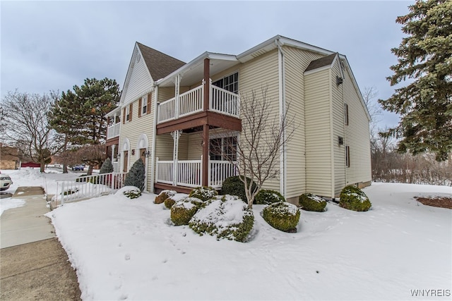 view of snow covered exterior with a balcony