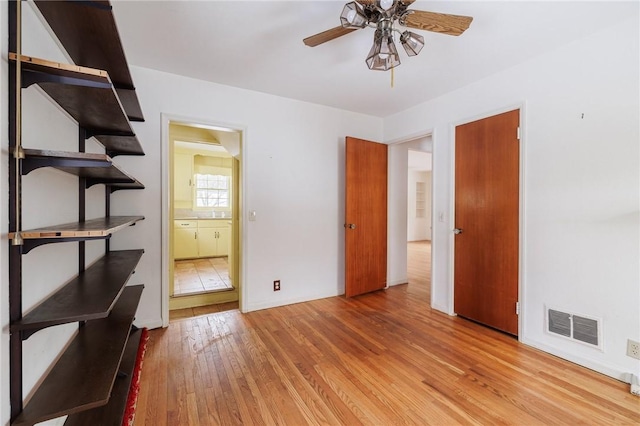 interior space with light hardwood / wood-style floors and ensuite bathroom