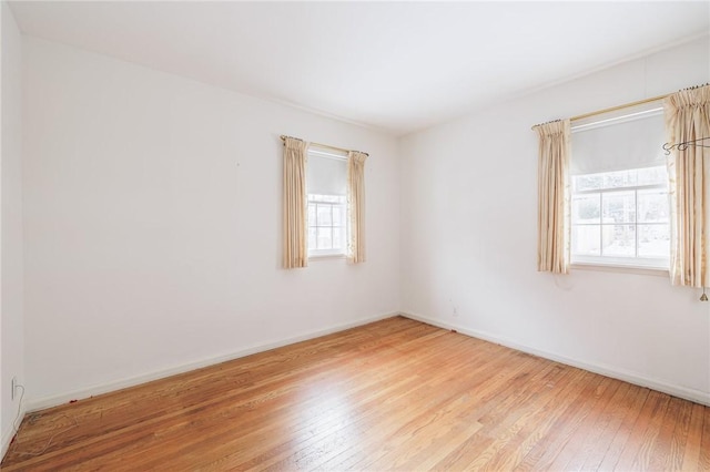 unfurnished room with light hardwood / wood-style flooring