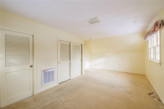 interior space with lofted ceiling and light carpet