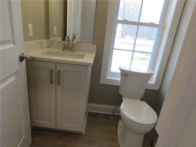 bathroom featuring vanity, toilet, and wood-type flooring