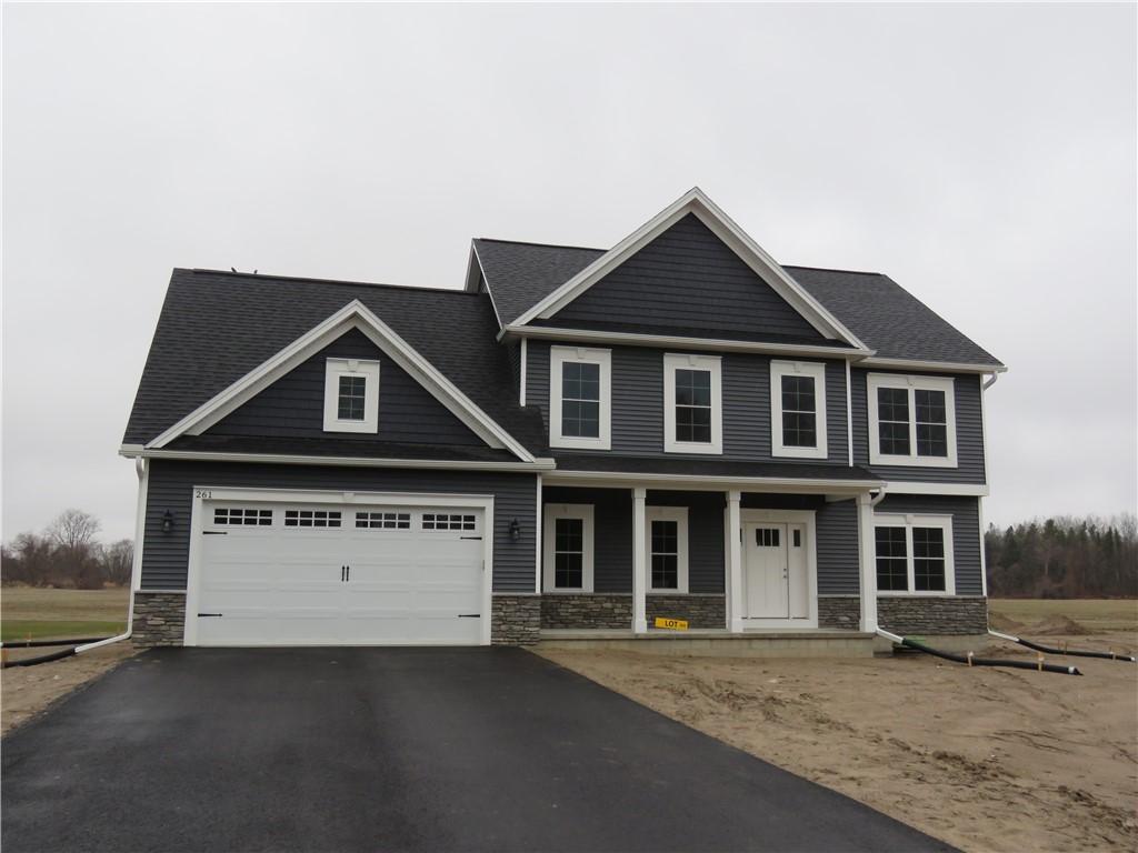 craftsman-style home with stone siding, driveway, covered porch, and an attached garage