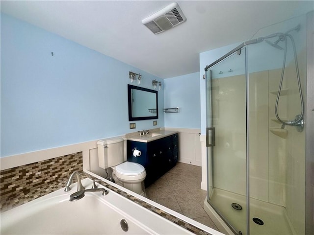 bathroom featuring walk in shower, vanity, toilet, and tile patterned flooring