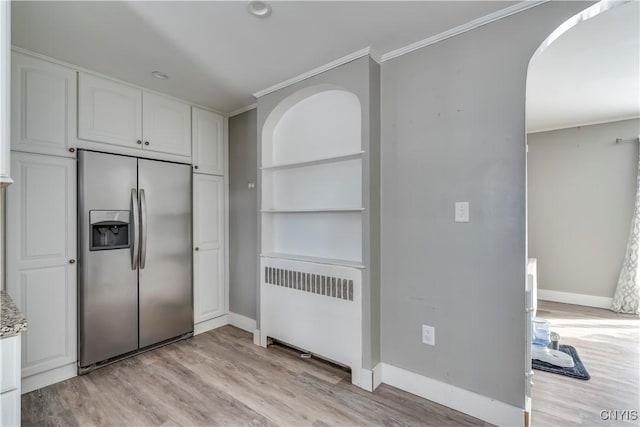 11190 US Route 11, Adams, NY 13605 - kitchen with stainless steel refrigerator with ice dispenser, radiator, white cabinetry, light wood finished floors, and ornamental molding