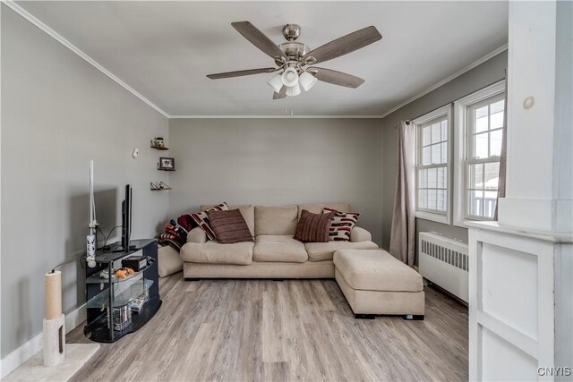 11190 US Route 11, Adams, NY 13605 - living room featuring radiator heating unit, crown molding, wood finished floors, a ceiling fan, and baseboards