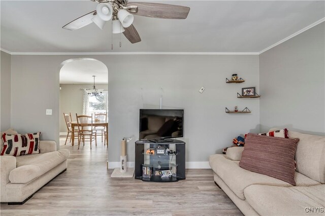 11190 US Route 11, Adams, NY 13605 - living area with ornamental molding, arched walkways, wood finished floors, a ceiling fan, and baseboards