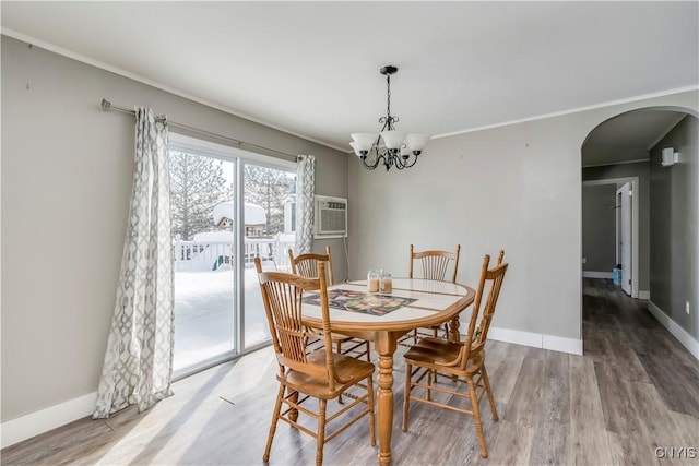 11190 US Route 11, Adams, NY 13605 - dining area featuring hardwood / wood-style flooring, crown molding, a wall mounted AC, and a chandelier