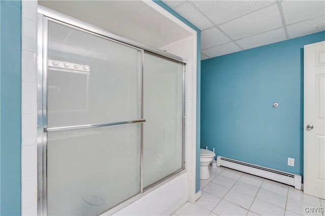 11190 US Route 11, Adams, NY 13605 - bathroom with a paneled ceiling, shower / bath combination with glass door, baseboard heating, tile patterned floors, and toilet