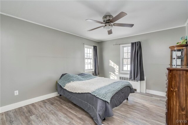 11190 US Route 11, Adams, NY 13605 - bedroom featuring radiator heating unit, crown molding, light wood-style flooring, baseboards, and a ceiling fan