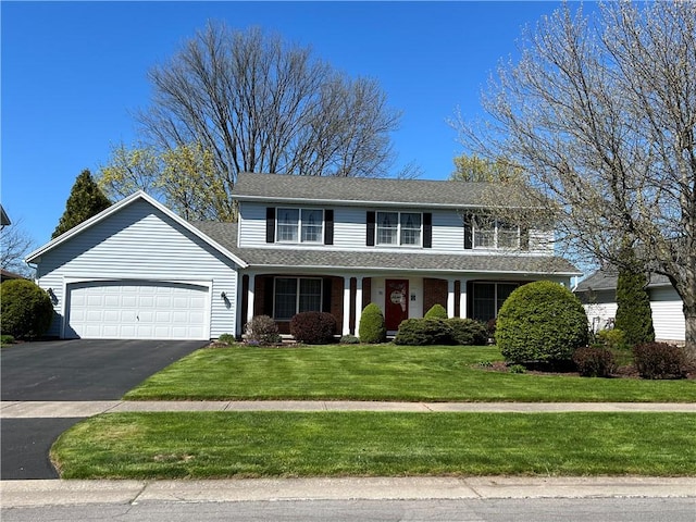 view of front of home featuring a garage and a front lawn