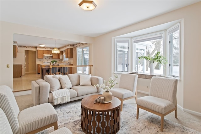 living room featuring a healthy amount of sunlight and light carpet