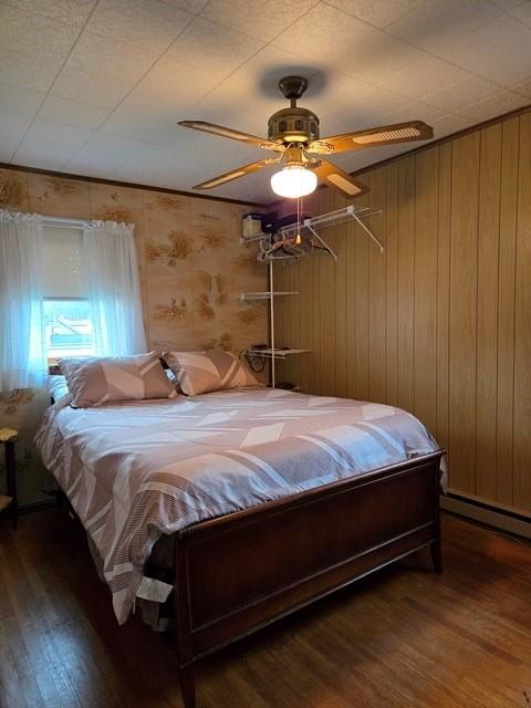 bedroom with ceiling fan and dark hardwood / wood-style floors