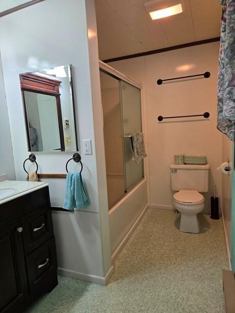 full bathroom with vanity, bath / shower combo with glass door, and toilet