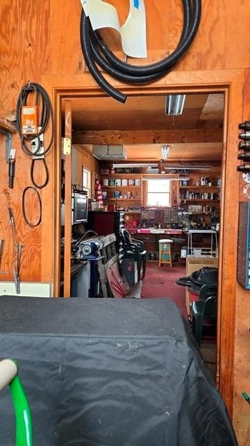 interior space with a workshop area and wood walls