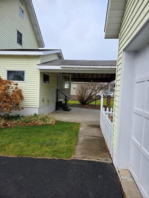 exterior space with a yard and a carport