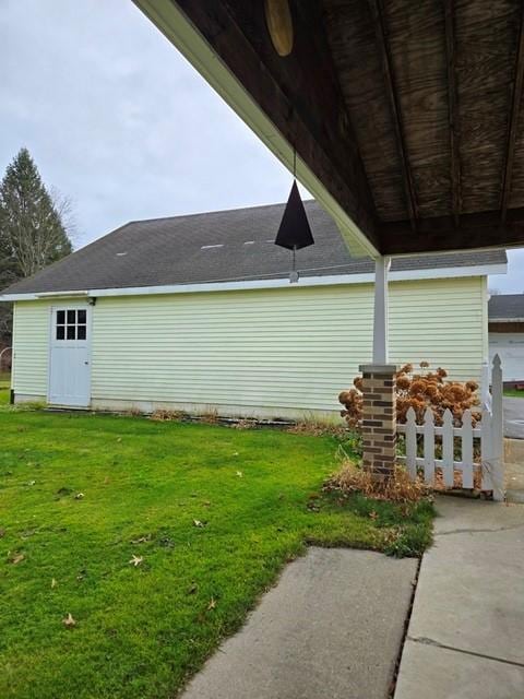 view of property exterior with a patio and a lawn