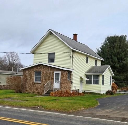 view of side of home with a lawn