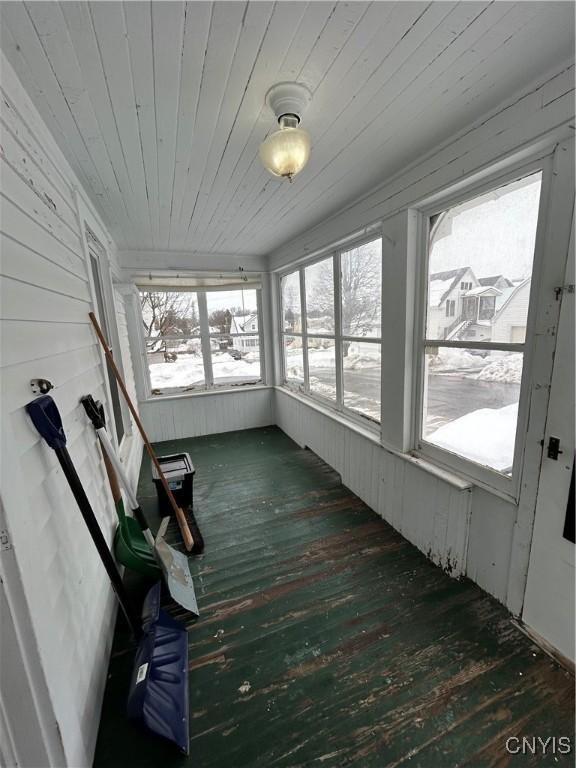 unfurnished sunroom with wood ceiling