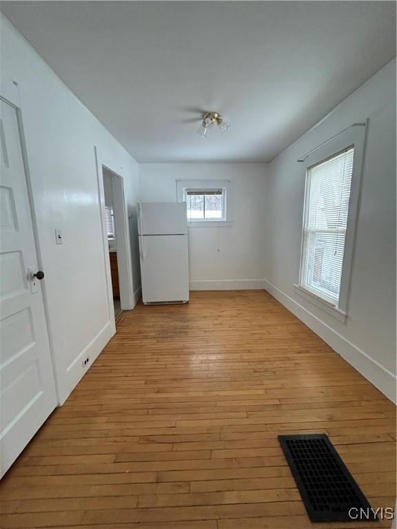 unfurnished room with light hardwood / wood-style floors