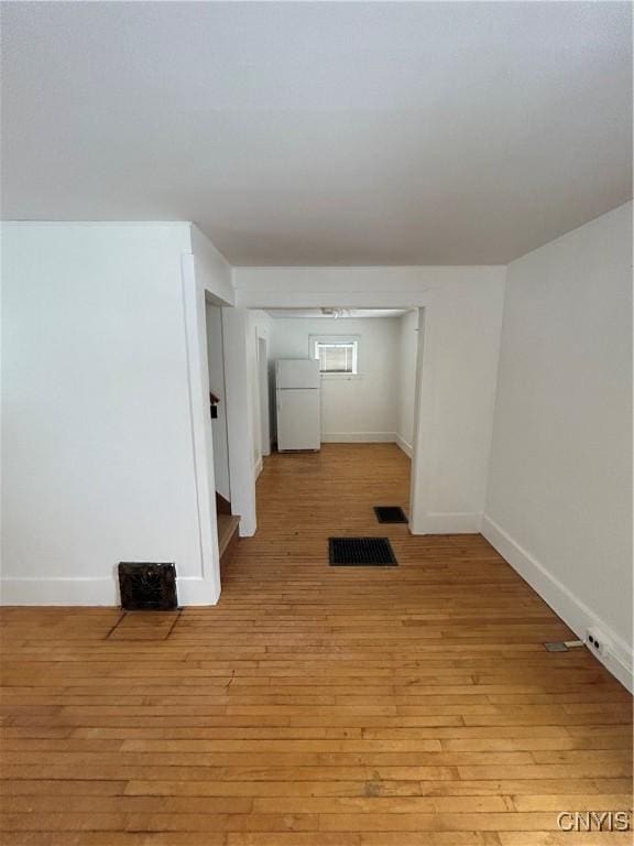 unfurnished room with light wood-type flooring