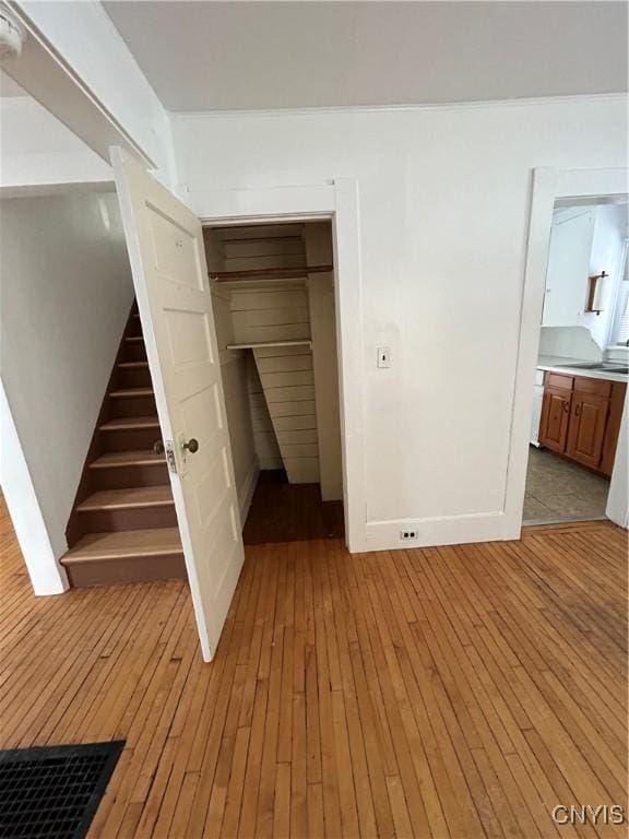 unfurnished bedroom with light hardwood / wood-style floors and a closet