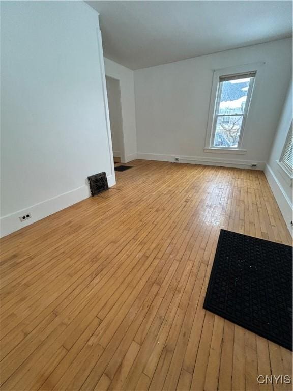 spare room with light hardwood / wood-style floors