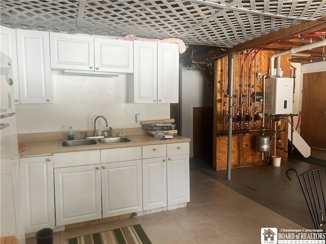 kitchen featuring white cabinetry, sink, light tile patterned floors, and tankless water heater