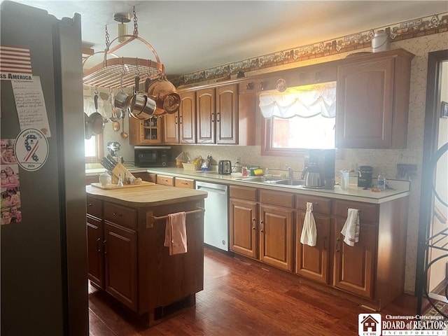 kitchen with dark wood-type flooring, butcher block counters, sink, tasteful backsplash, and stainless steel dishwasher