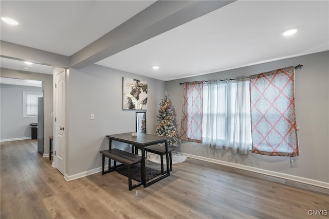 dining space with wood-type flooring