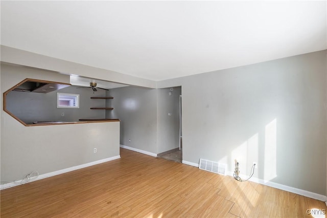 empty room featuring hardwood / wood-style flooring and ceiling fan