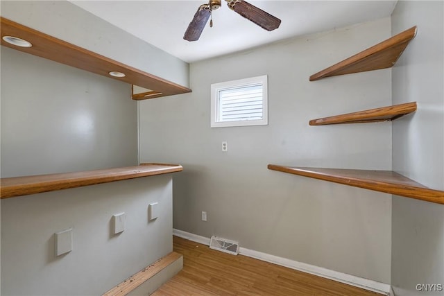 laundry room featuring light hardwood / wood-style flooring and ceiling fan