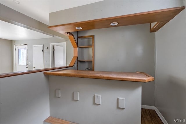 bar with dark wood-type flooring