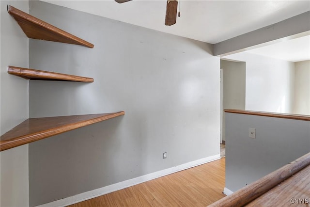 empty room with hardwood / wood-style floors and ceiling fan