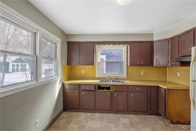 kitchen with sink, dark brown cabinetry, and decorative backsplash