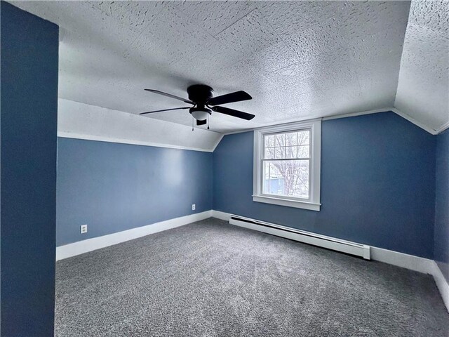 additional living space with lofted ceiling, a baseboard radiator, a textured ceiling, and carpet