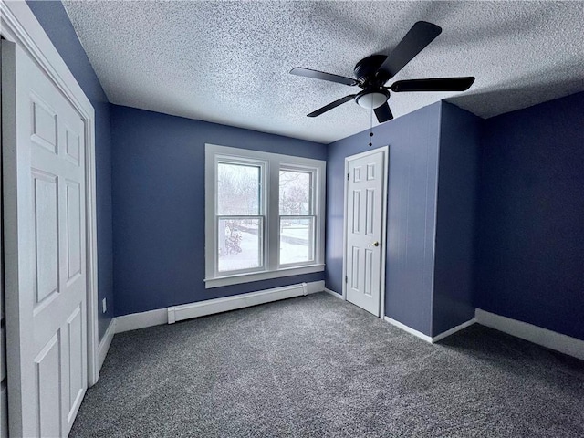 unfurnished bedroom featuring a baseboard radiator, a textured ceiling, ceiling fan, and dark carpet