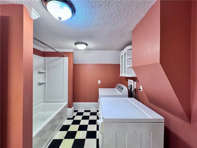 washroom featuring a textured ceiling and independent washer and dryer