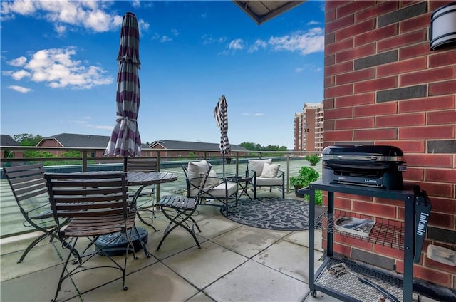 view of patio featuring a balcony